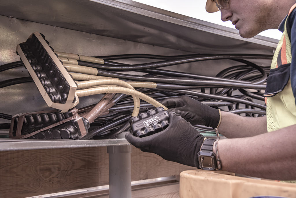 Man looking at electrical wires